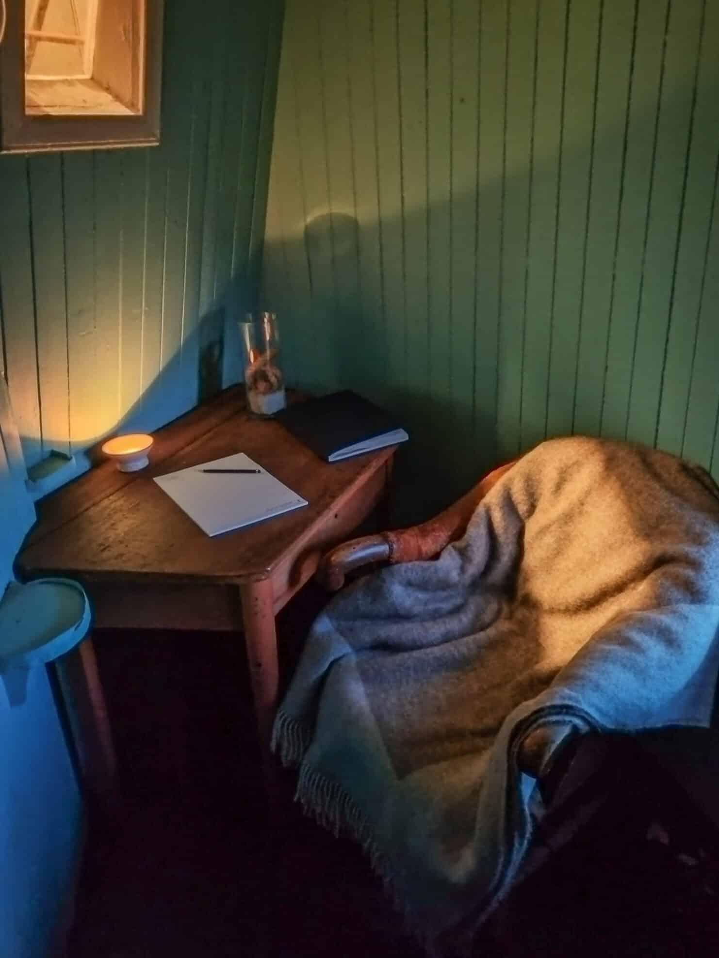Small meeting room inside Ona Lighthouse, with atmospheric lighting and warm tones.